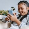 concentrated asian girl looking at smartphone